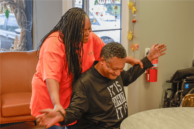 Tashua helping a participant with an exercise