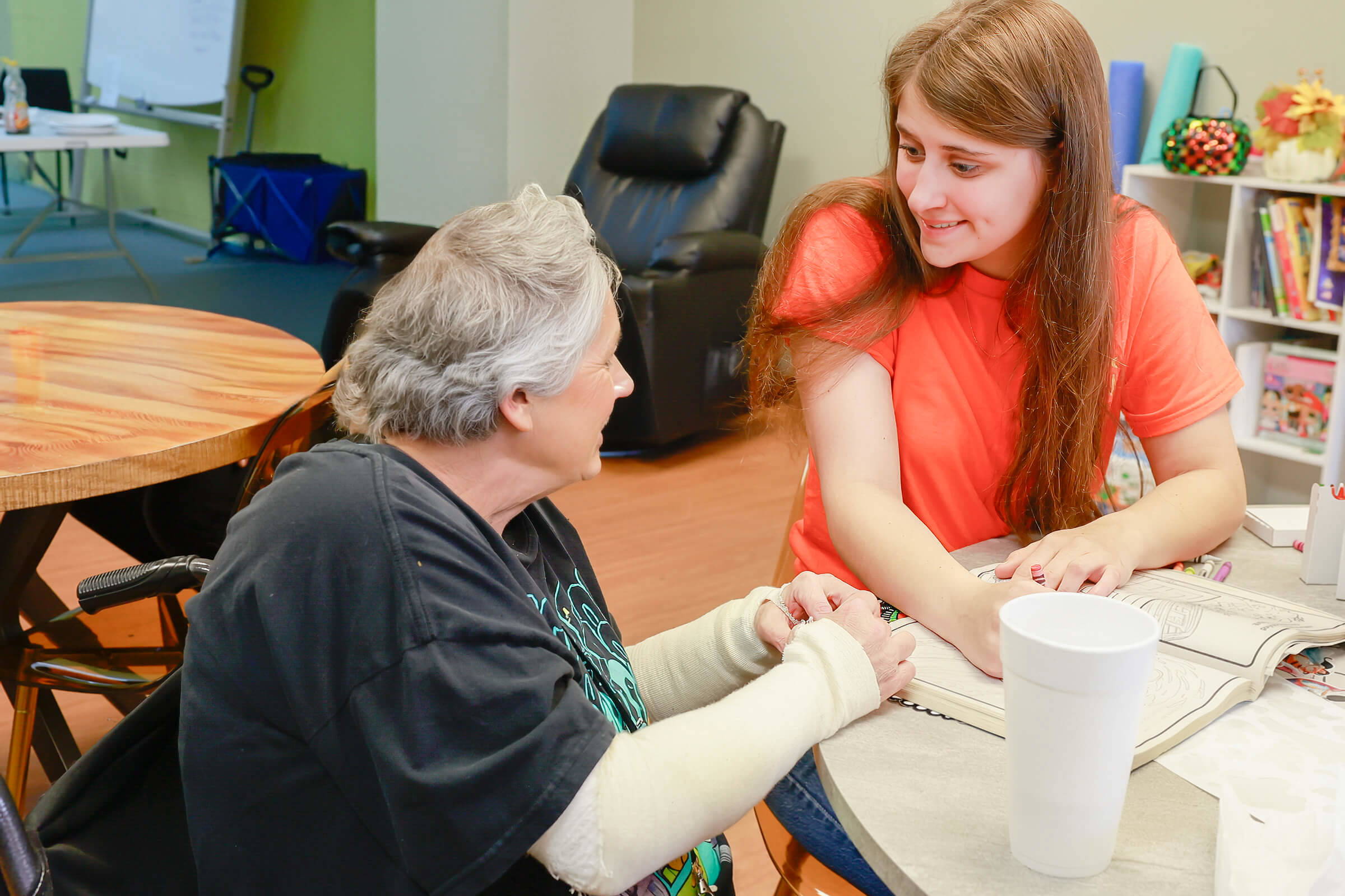 Staff member in conversation with an older woman