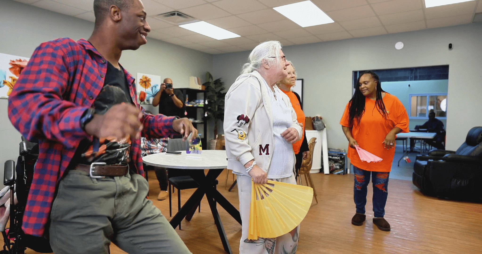 Tashua and a group of happy adults taking part in a fun activity